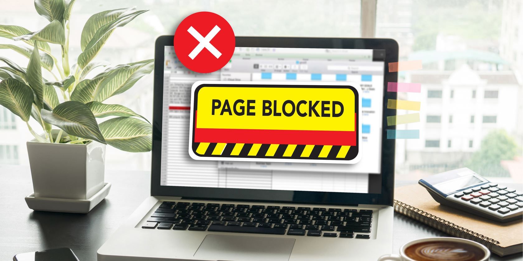 A Page Blocked message displayed on a laptop.