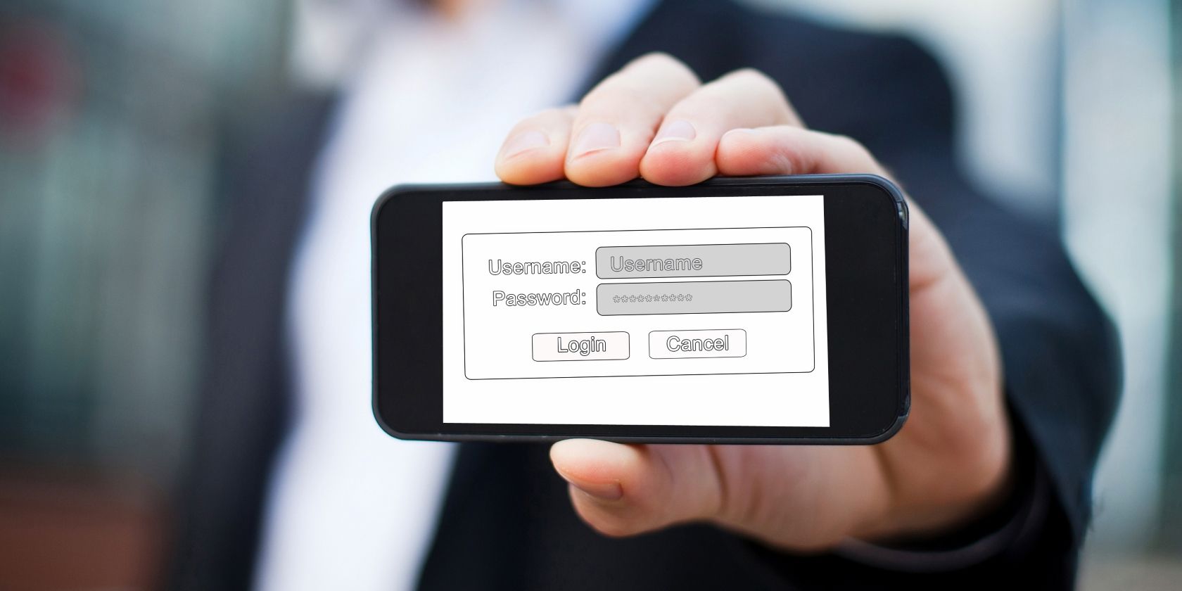 man holding phone showing credential entering screen