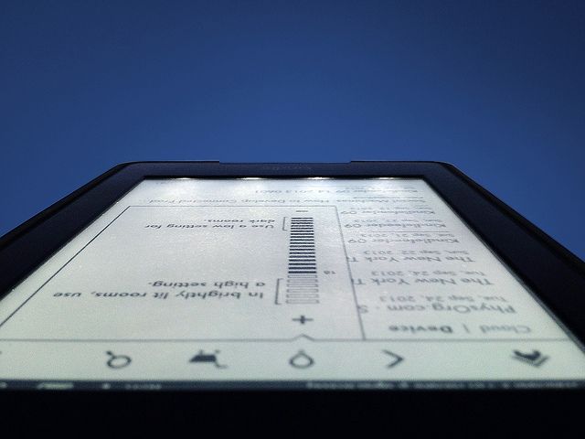 An image showing the Kindle Paperwhite (2012) with the front LEDs on
