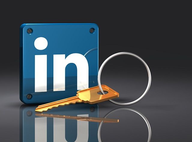 3d illustration of a large brass key lying in front of an upright blue LinkedIn logo with rivets