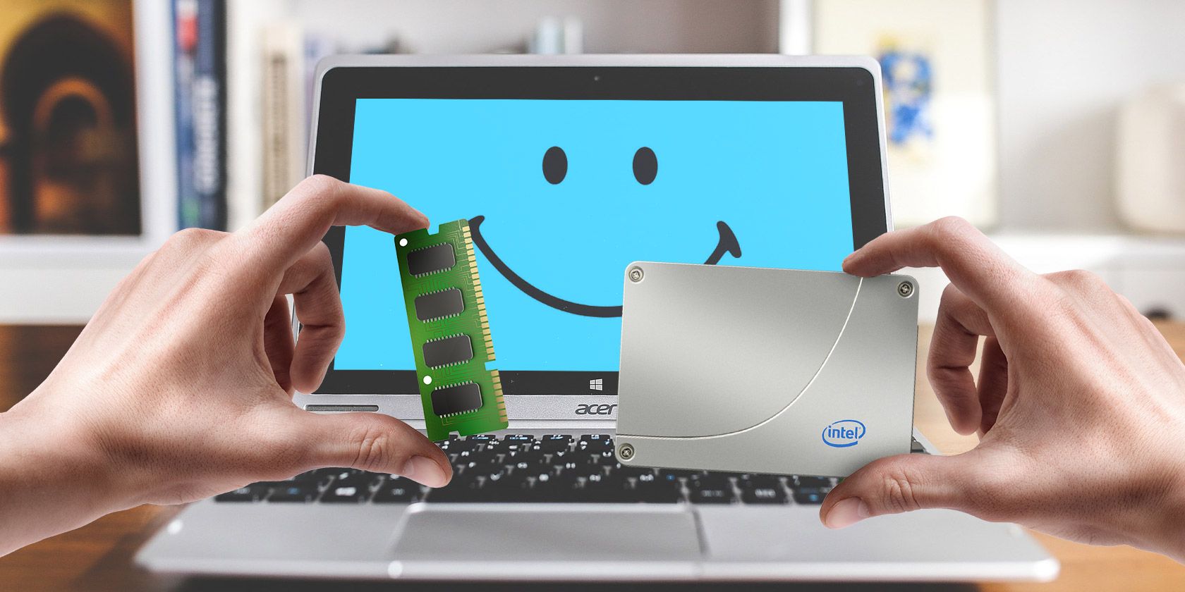 Hands holding a RAM stick and a hard drive in front of a laptop with a smiley face on the screen