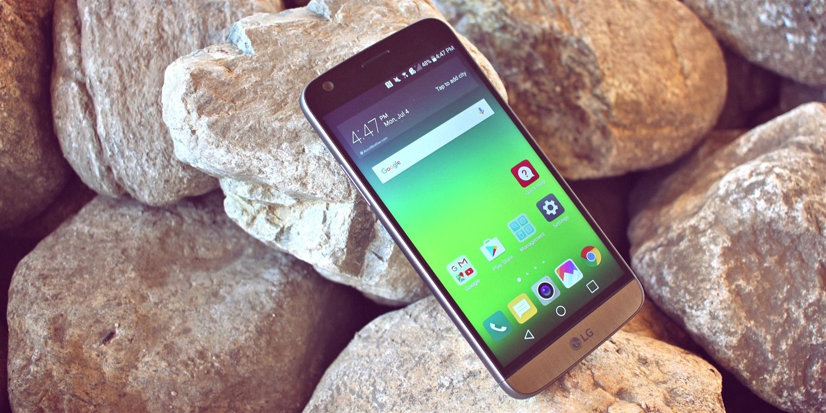 Android phone resting against rocks