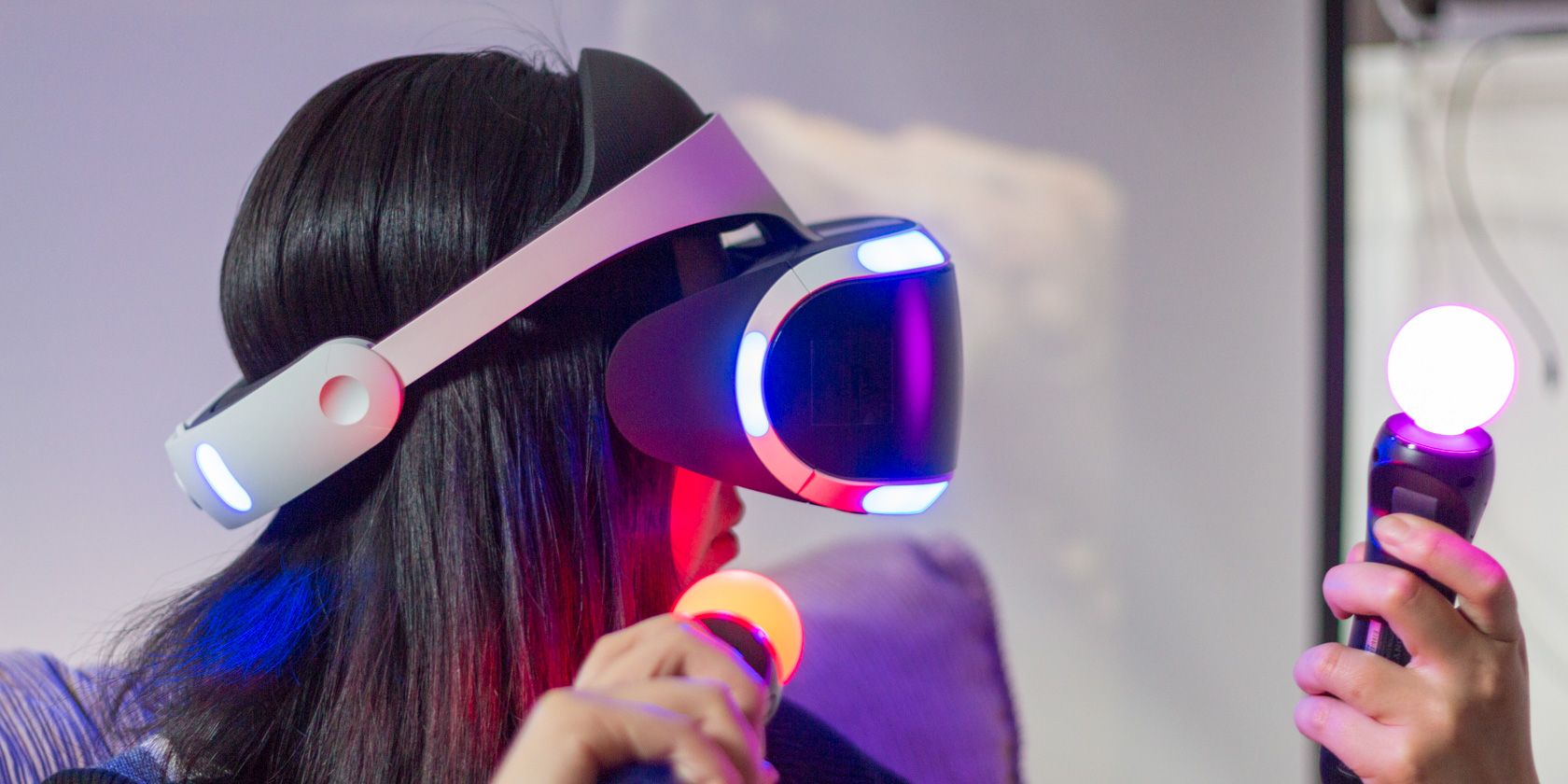 PSVR headset and controls being used by a woman