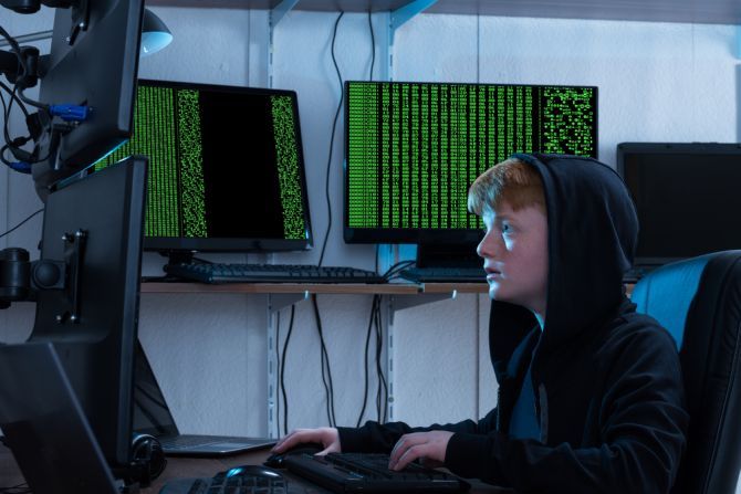 teen hacker using multiple computers