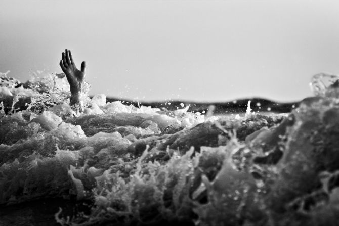 Hand Sticking Out of Drowning Ocean
