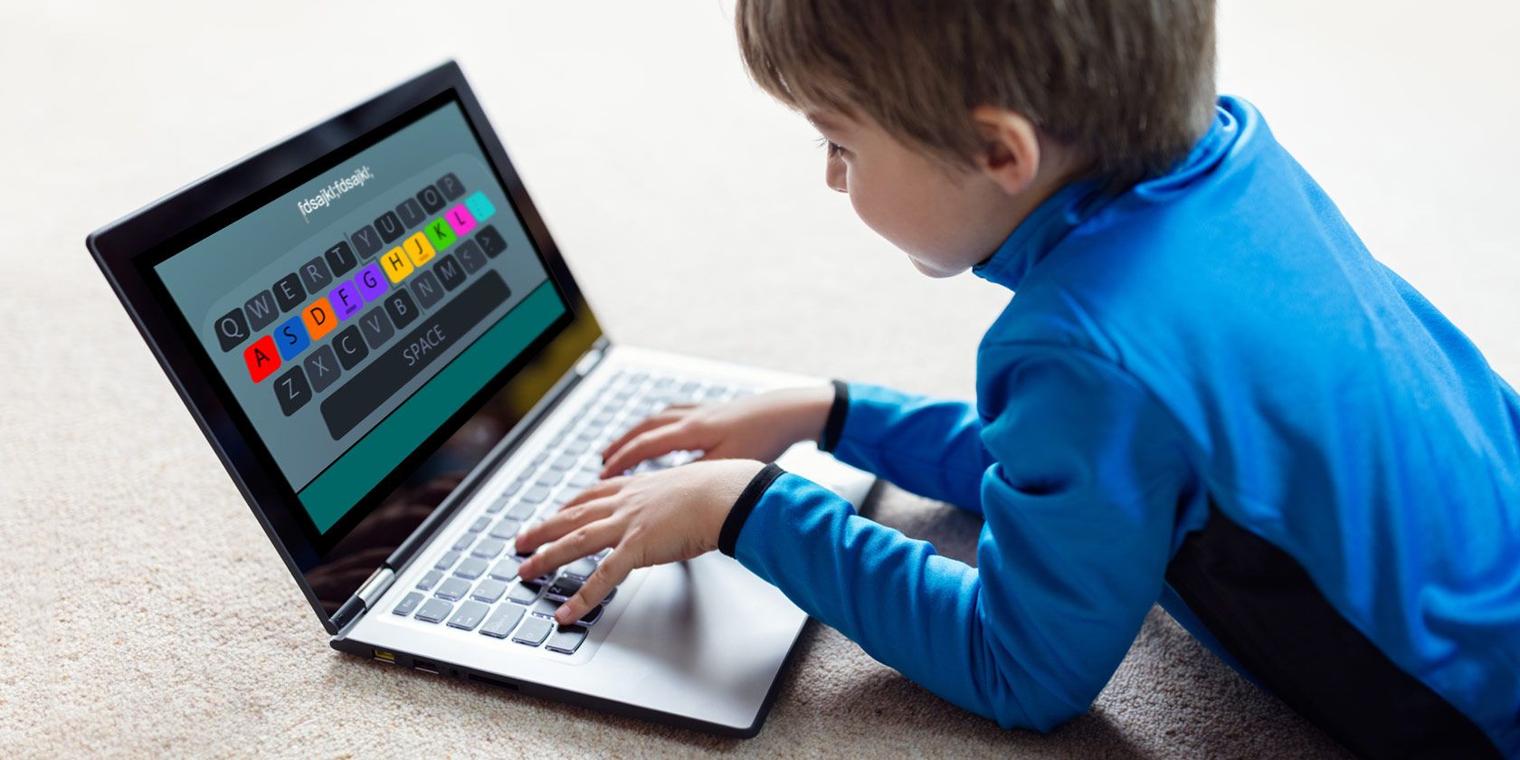 child playing typing game on laptop