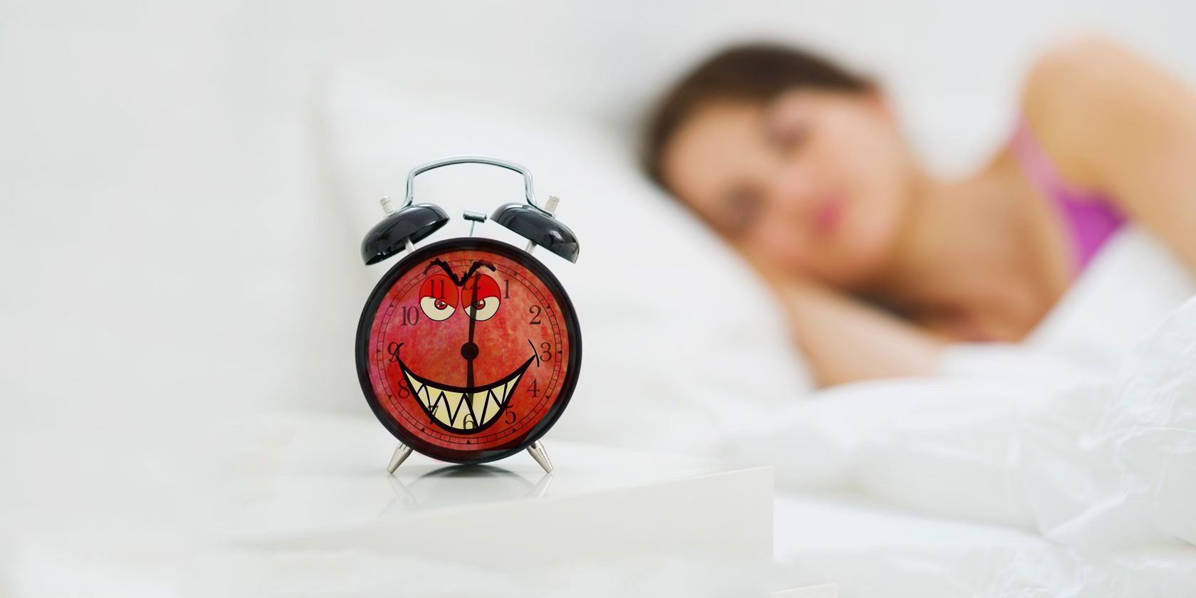 woman lying in bed, alarm clock on table with evil face