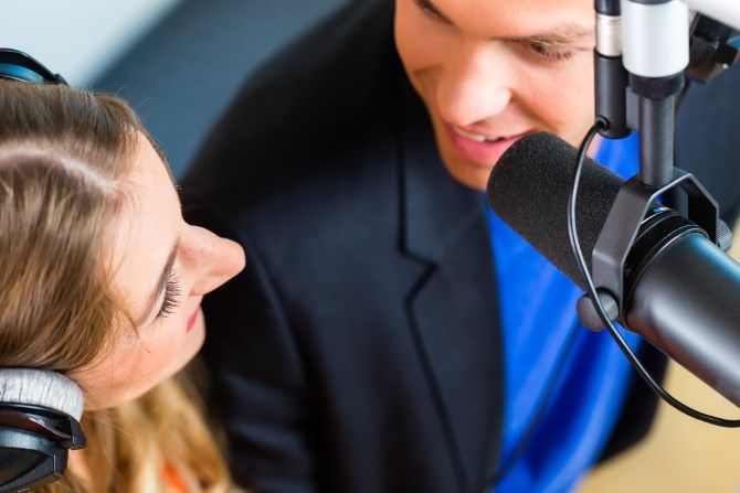 man and woman recording a podcast