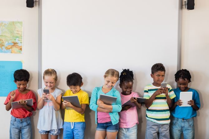 children holding tablets