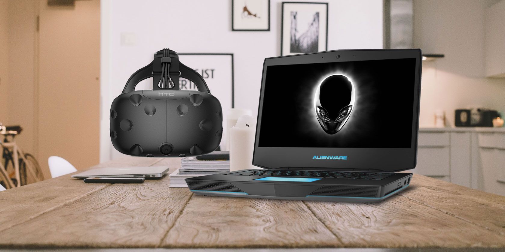 Gaming laptop and HTC Vive VR headset resting on desktop