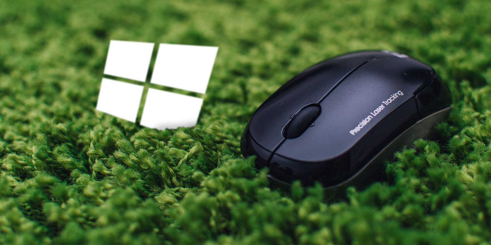 Wireless mouse and Windows logo on a green carpet