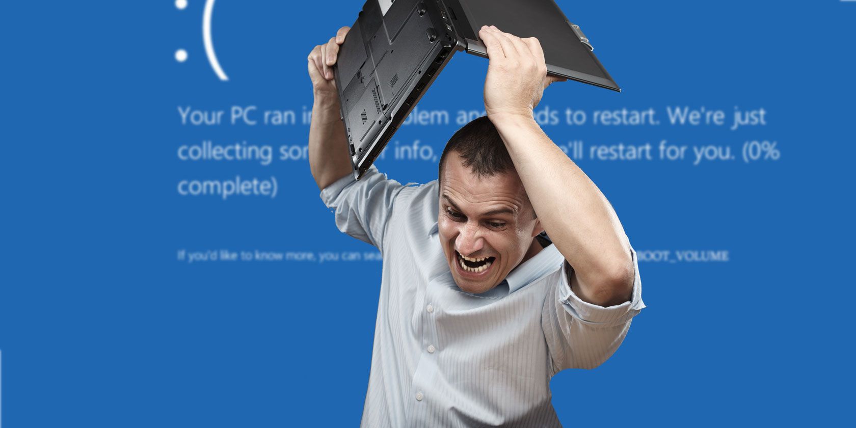 Man about to drop his laptop with blue windows error screen background.