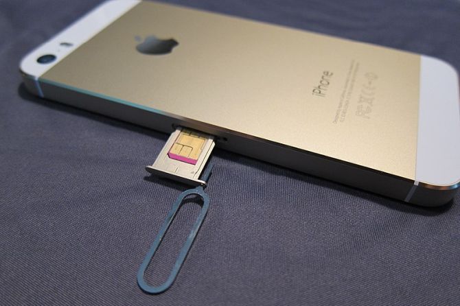 Paper clip ejecting SIM card from an iPhone