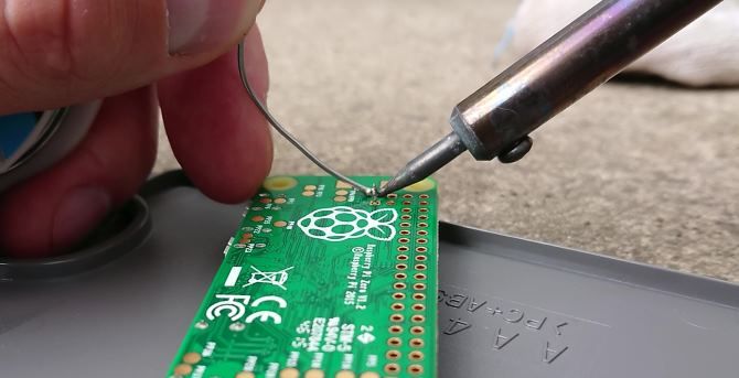 Soldering the header pins to the composite video on Raspberry Pi Zero