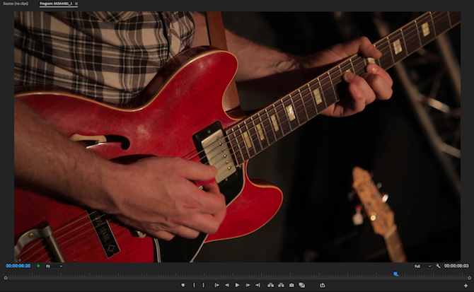 Person playing guitar, before color correction