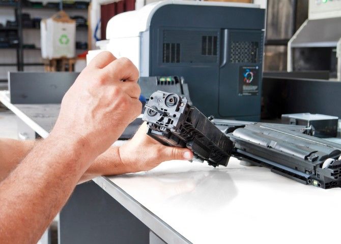 Hands repairing laser toner cartridge