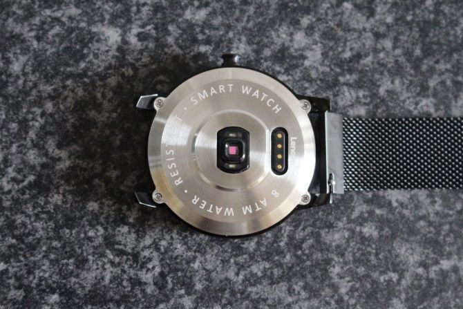 The Back Of The Lenovo Watch X Showing Charging Connection And Heart Rate Sensor