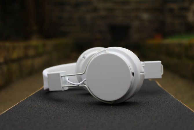 Urbanear Plattan 2 Bluetooth Headphones on a skateboard from the side