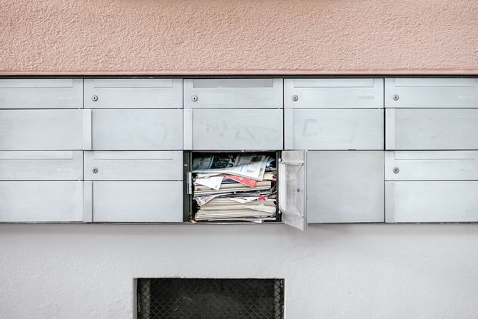 Targeted junk mail ads overflowing a mail box