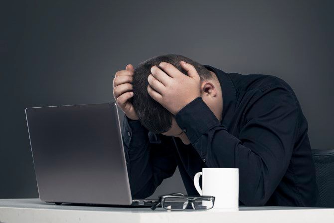 Man depressed with computer