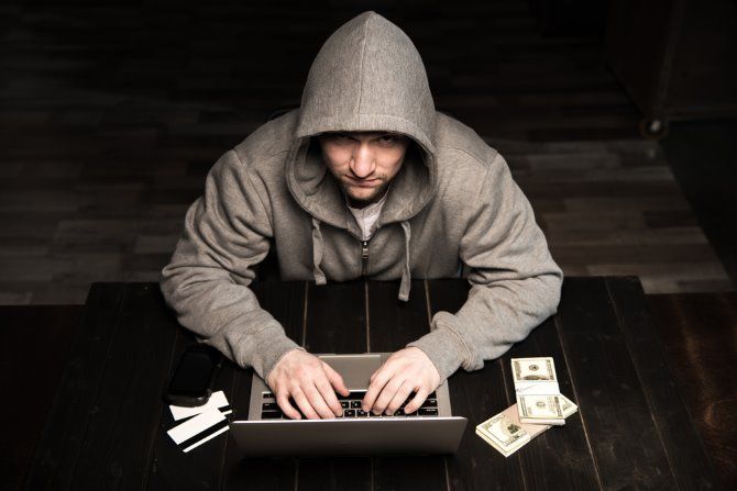 A hacker using a laptop