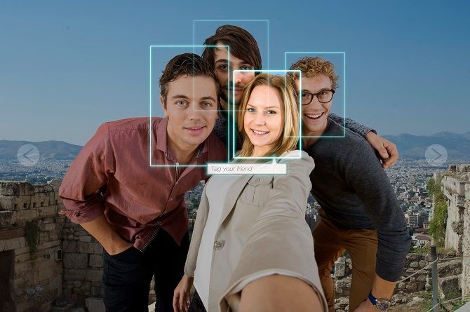 Photo of four people with facial recognition tagging