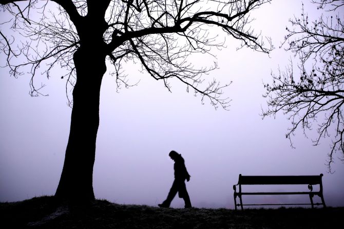 A person walking outside in fog