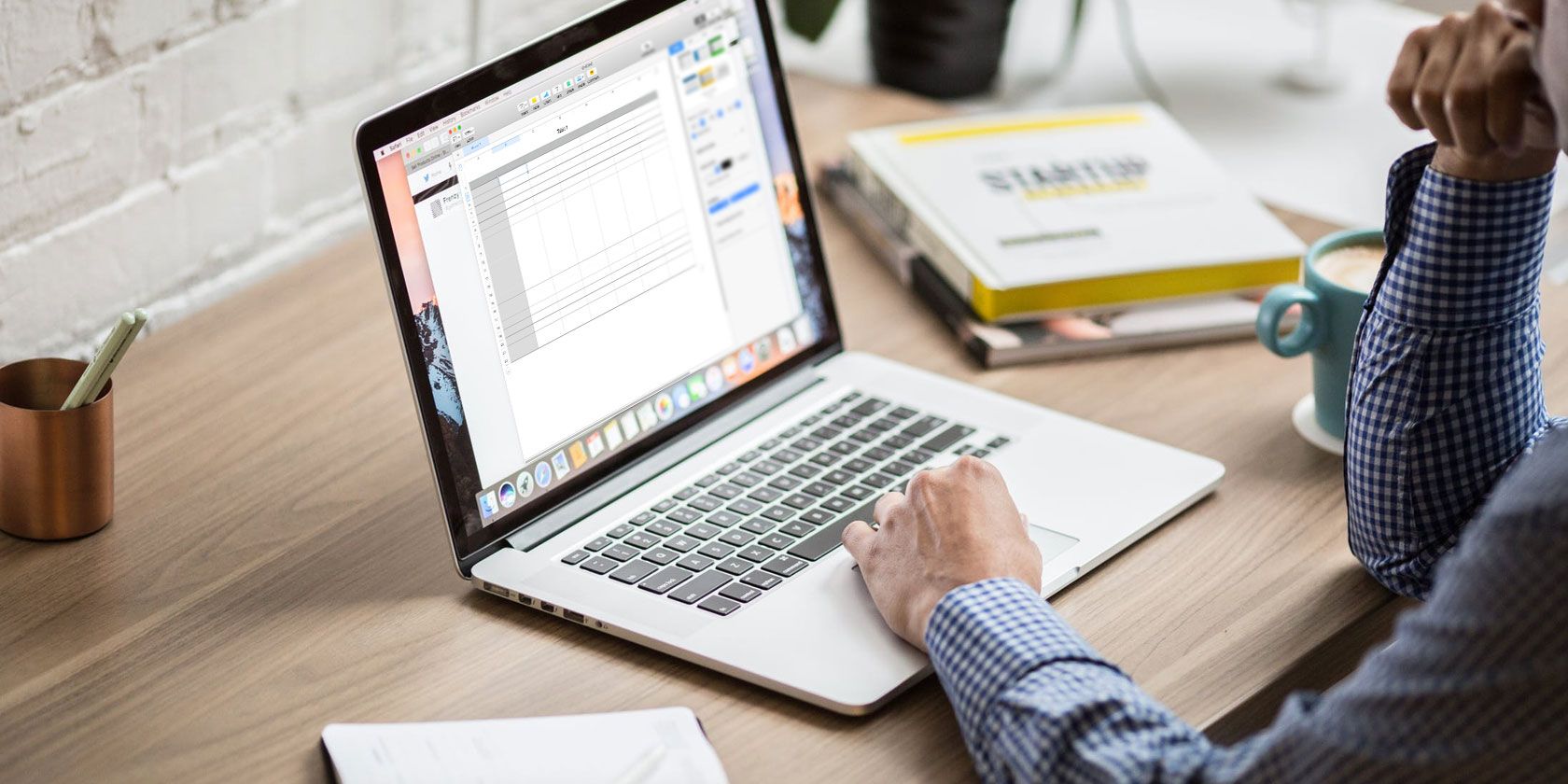 Person viewing spreadsheet on a Mac