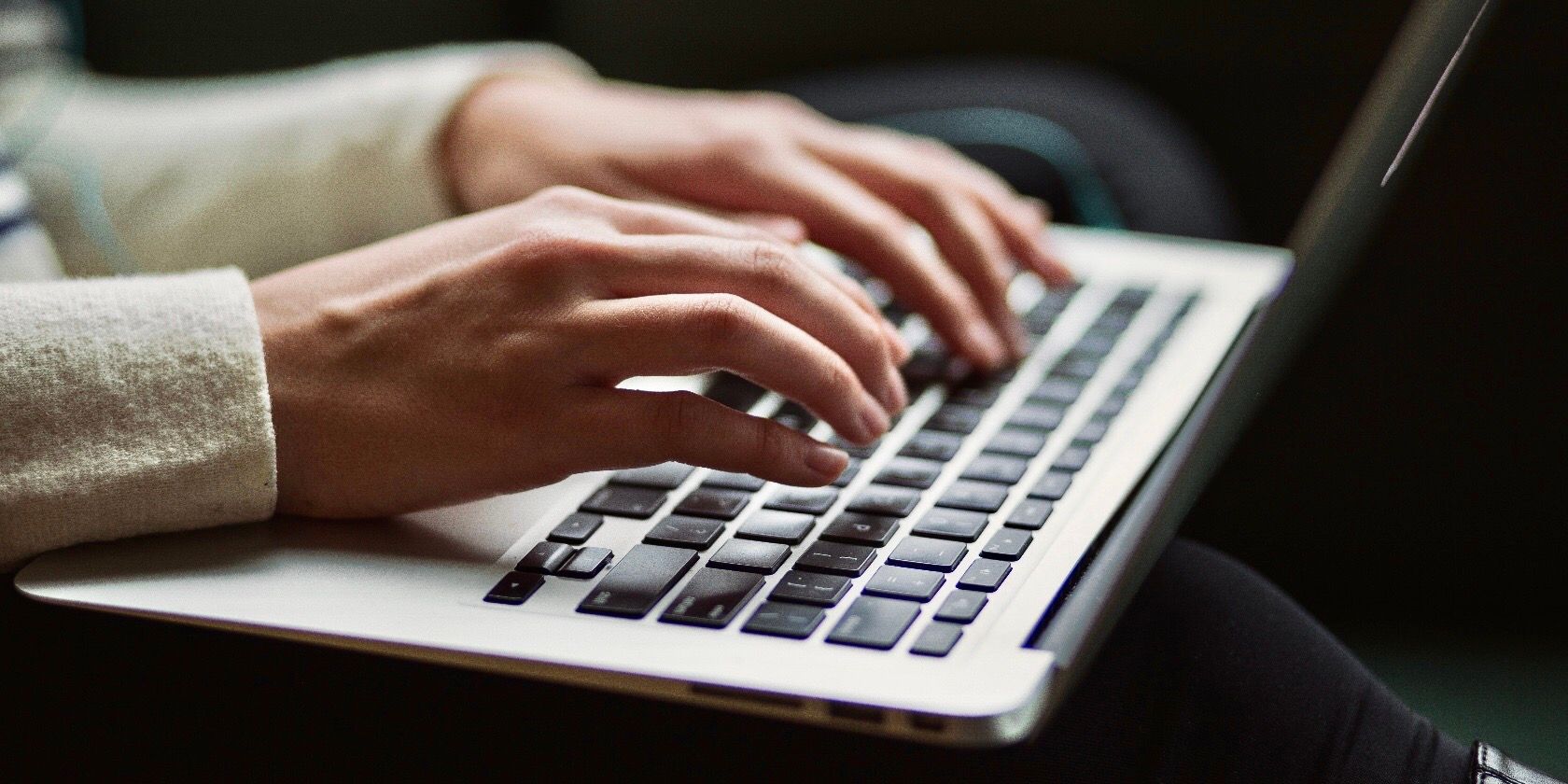 person typing on a MacBook keyboard