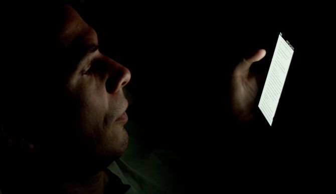 Man using phone in dark