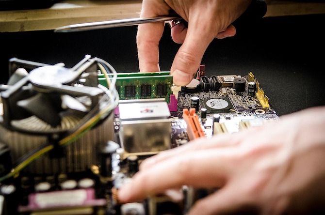Exposed PC motherboard undergoing repair