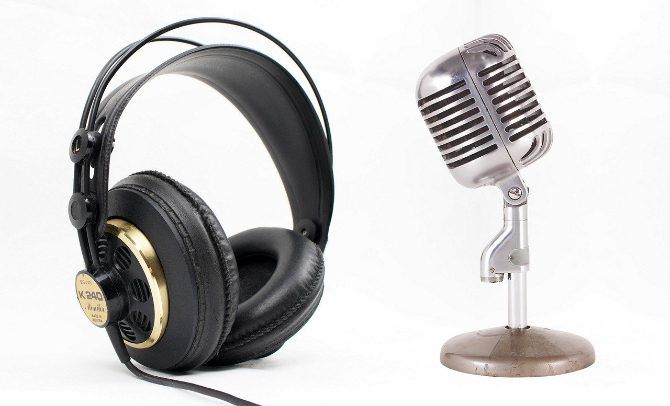 Headphones and microphone over a white background