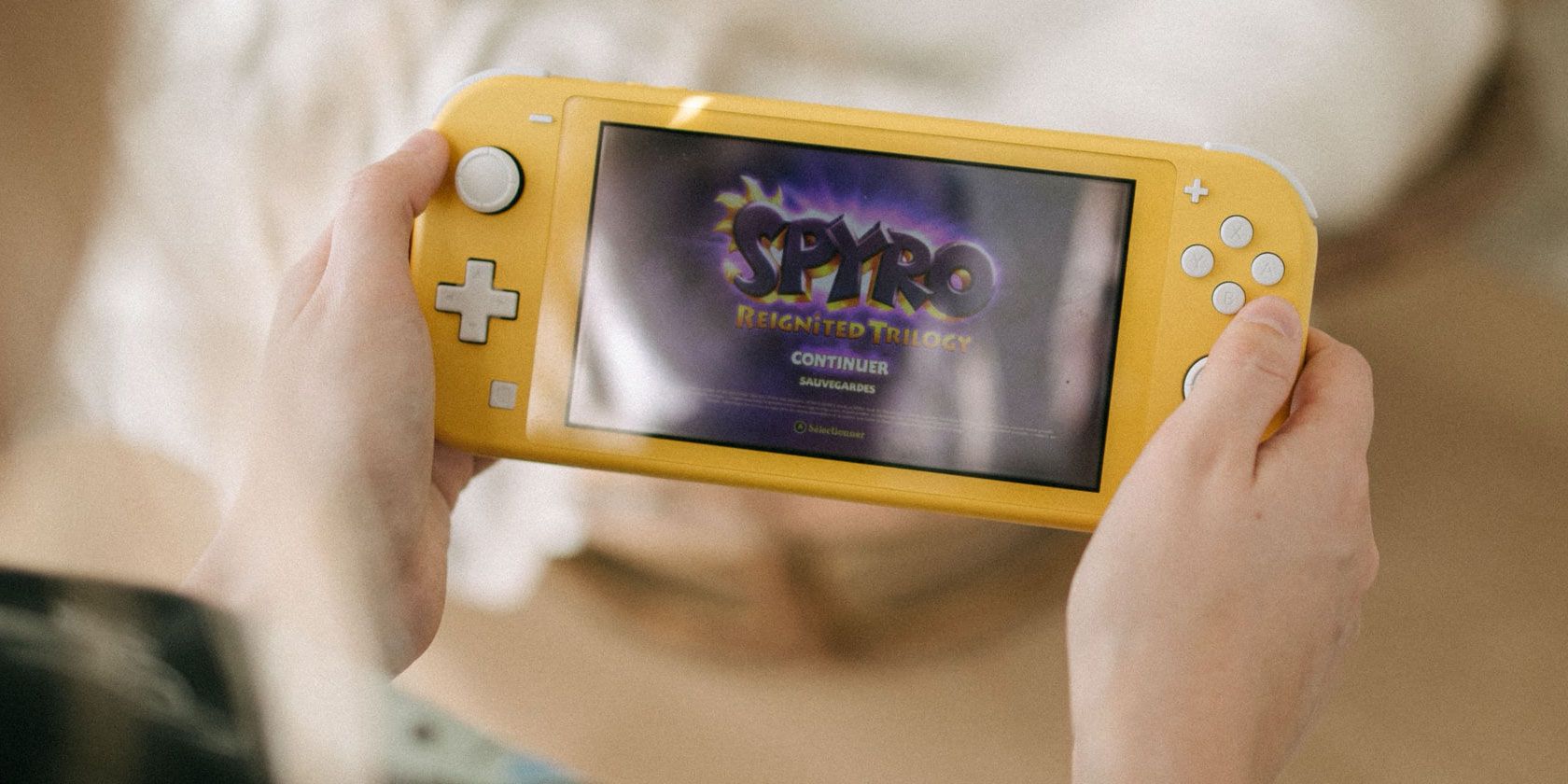 Spyro Reignited Trilogy title screen on yellow Nintendo Switch Lite
