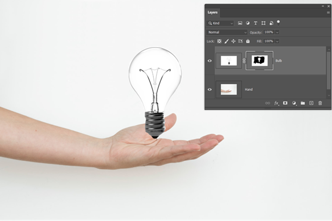 Photoshop layer masked image of hand and bulb