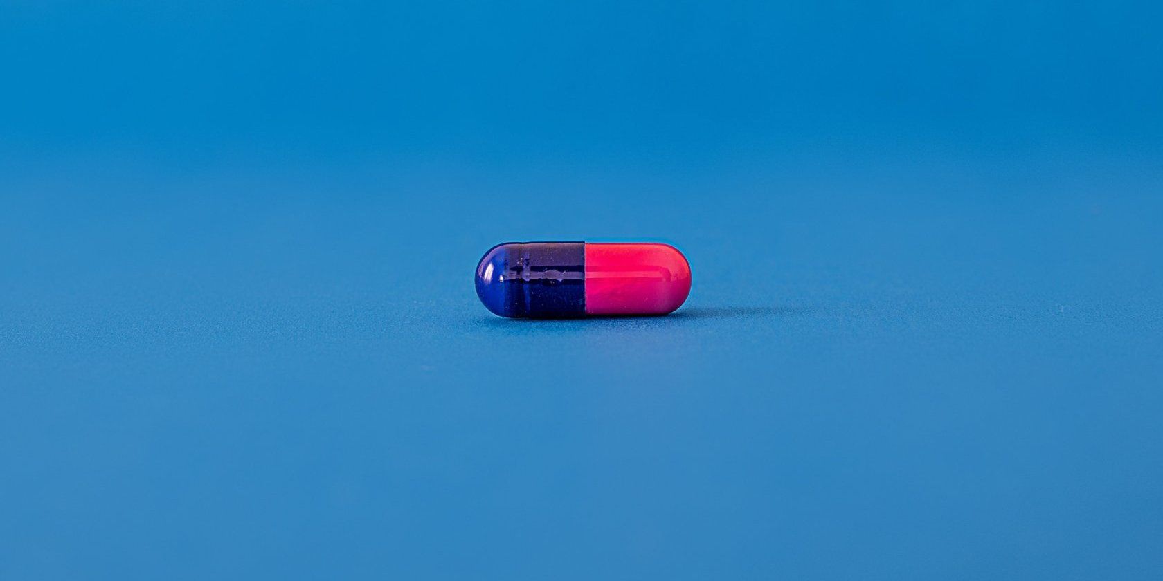 a red and blue pill on a blue background