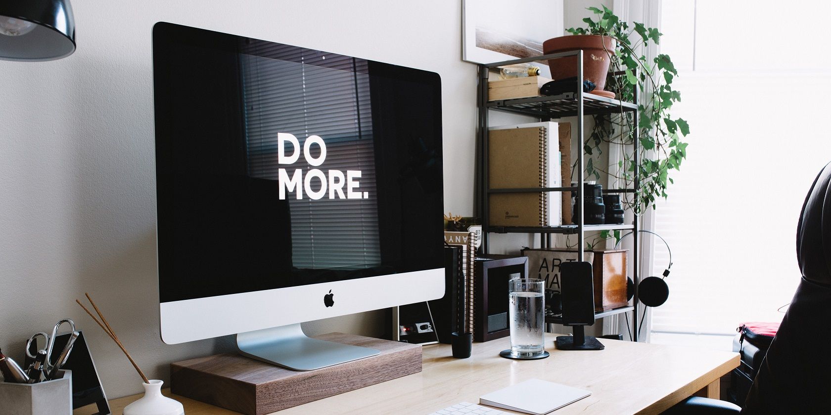 computer on a desk screen says Do More