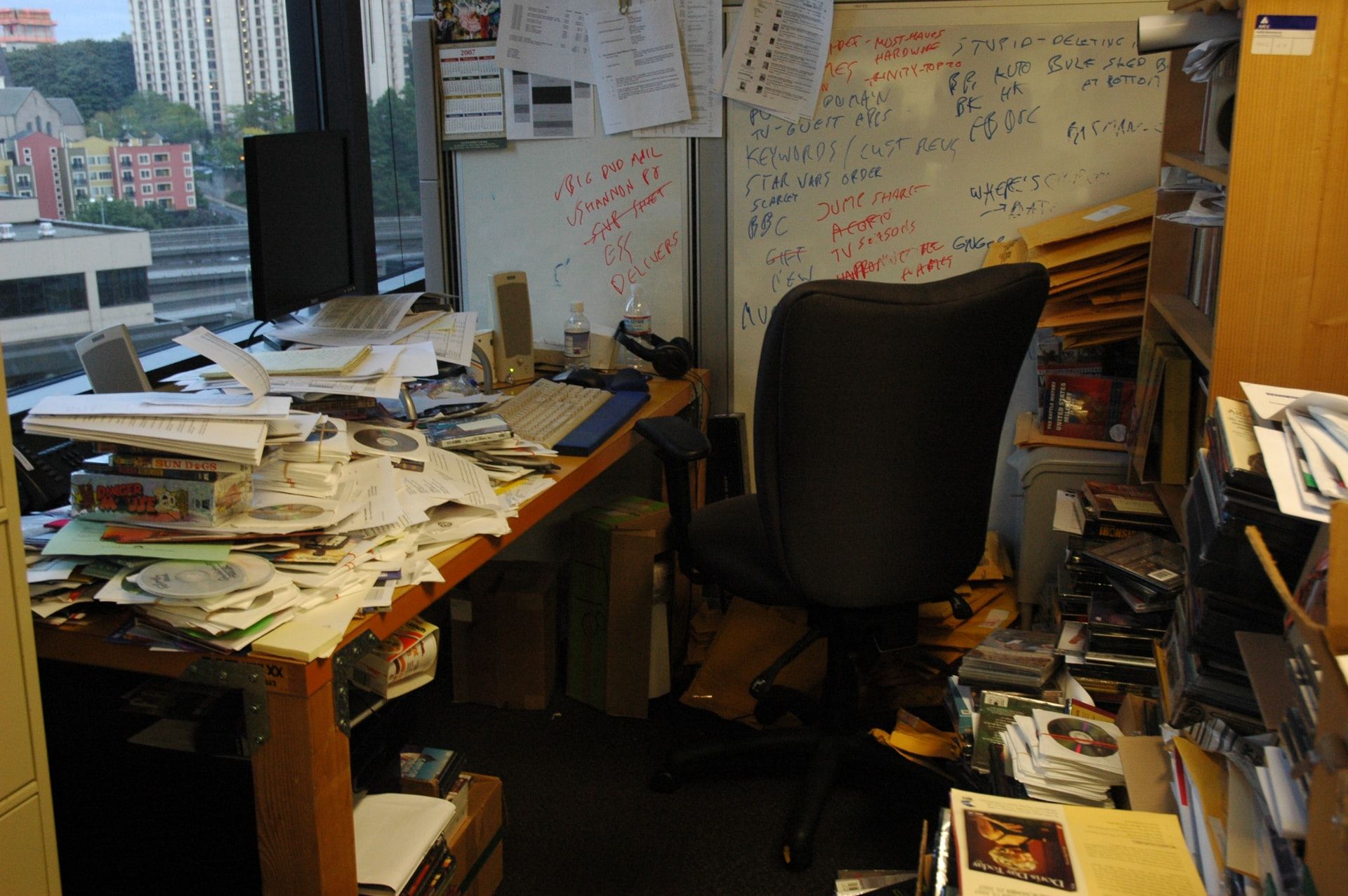 A messy office with lots of paper and trash