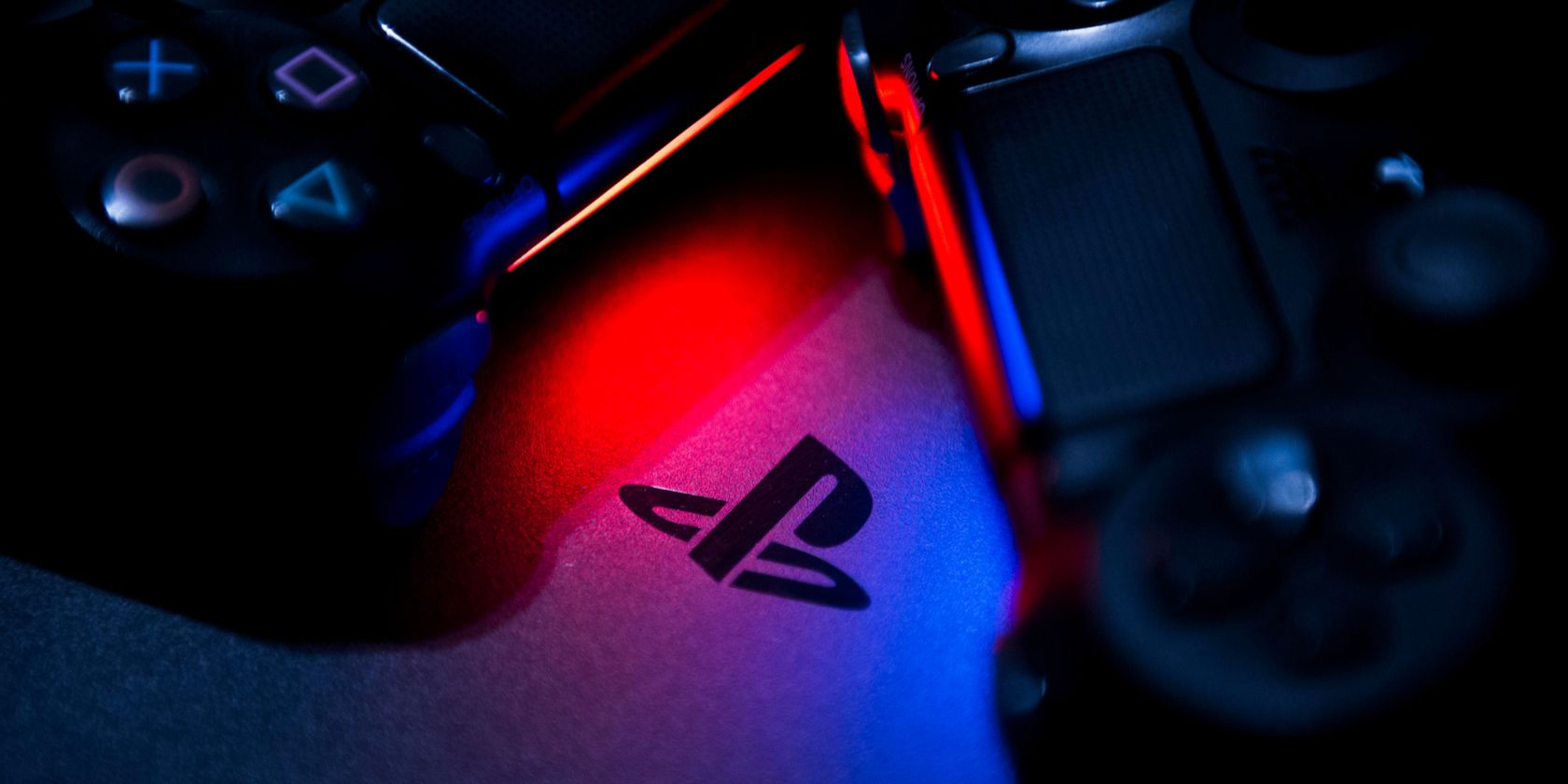 PlayStation logo between two PS4 controllers