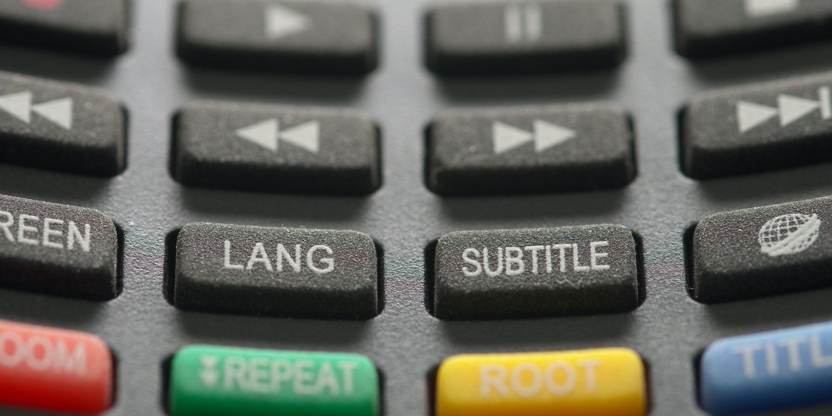 An extreme close-up photo of a TV remote control featuring a 