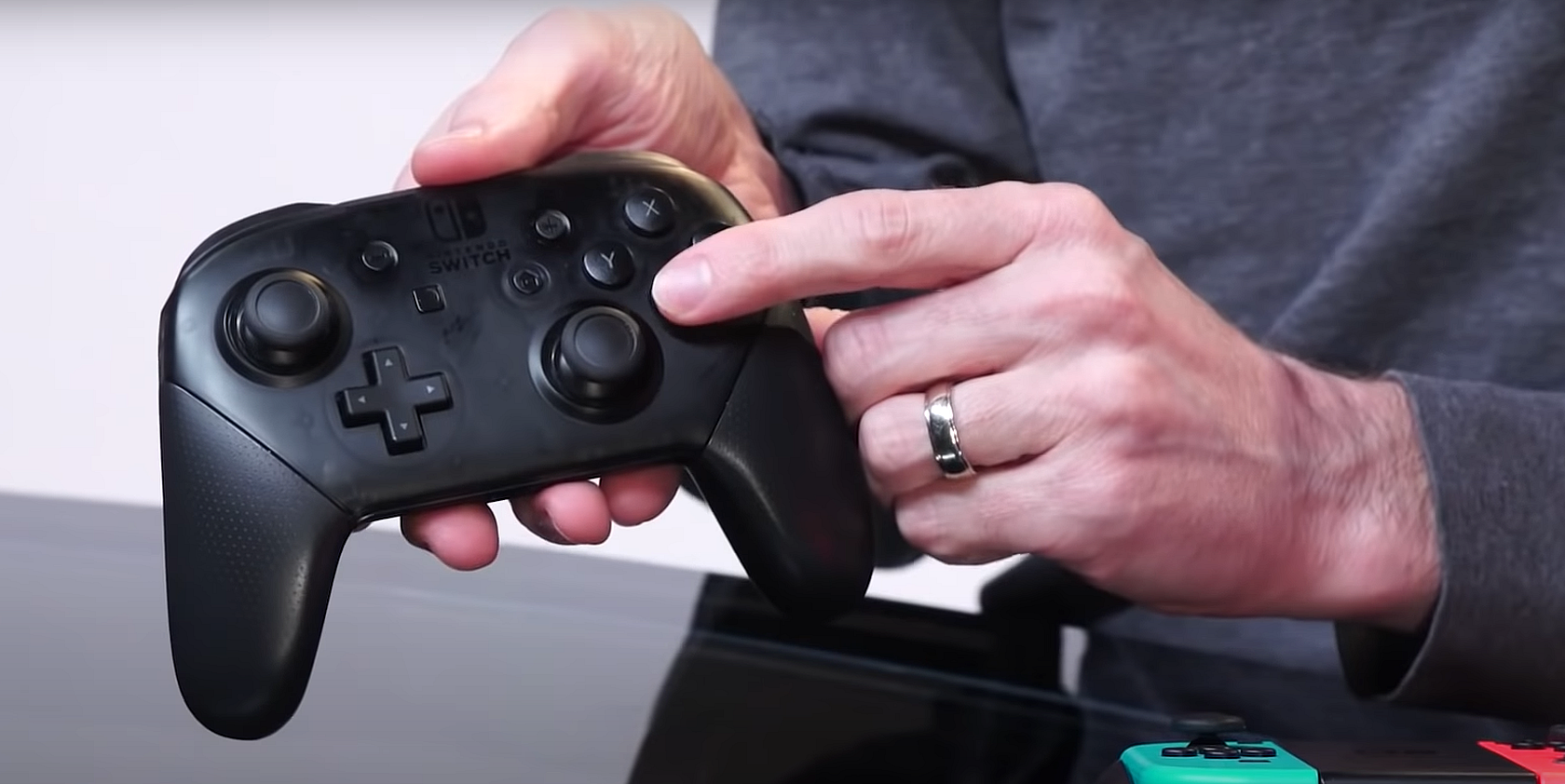Nintendo Switch Pro Controller in a man's hand