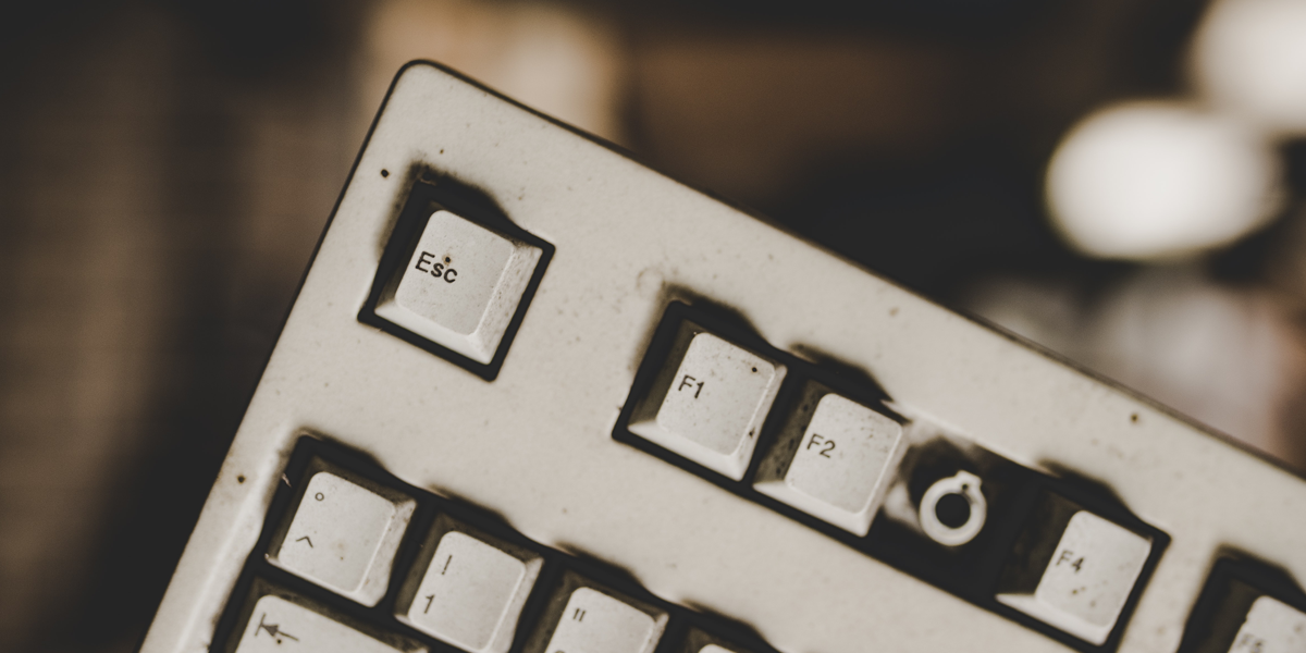 A closeup of the top left of a keyboard, focused on the ESC key