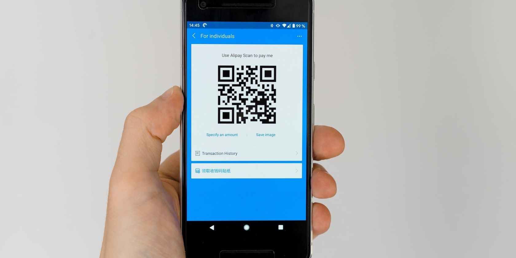 A photograph showing a QR code on a mobile phone screen
