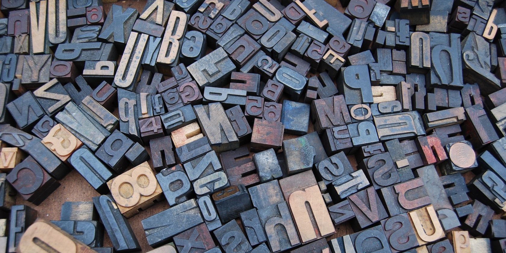 A photograph of various metal letterpress type characters