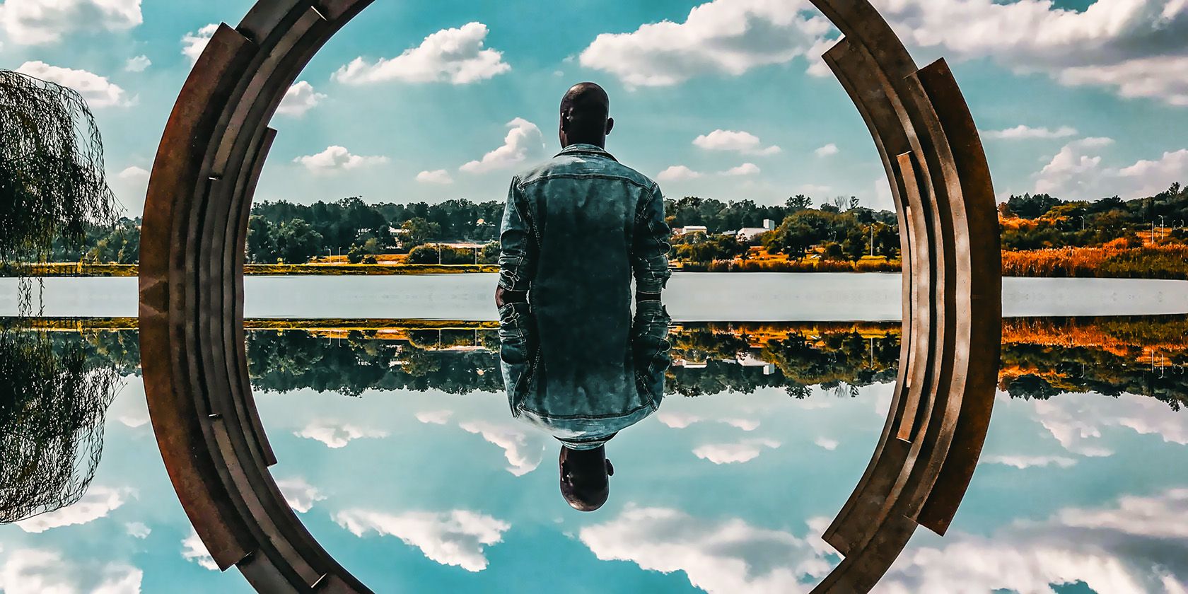 person sitting sky reflection
