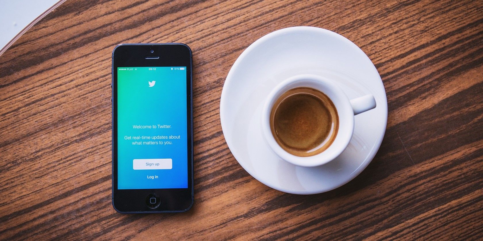 twitter on smartphone with coffee