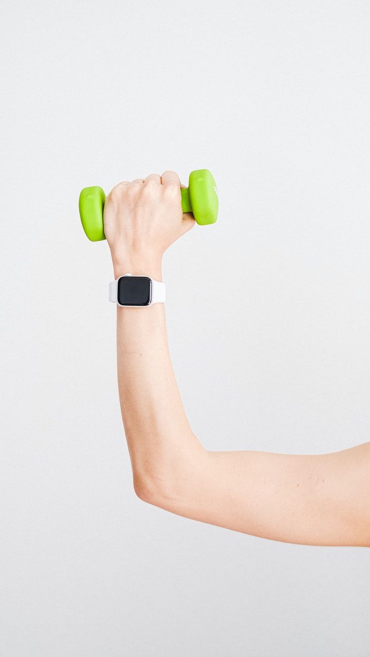 Apple Watch on arm Holding Dumbell
