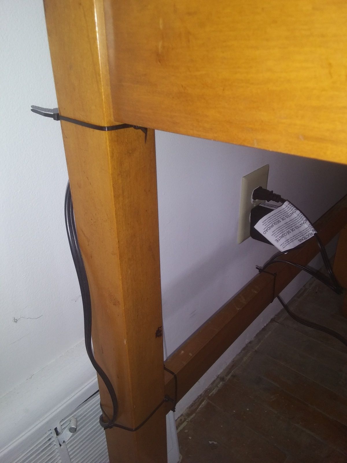 Zipties routing cable along a desk