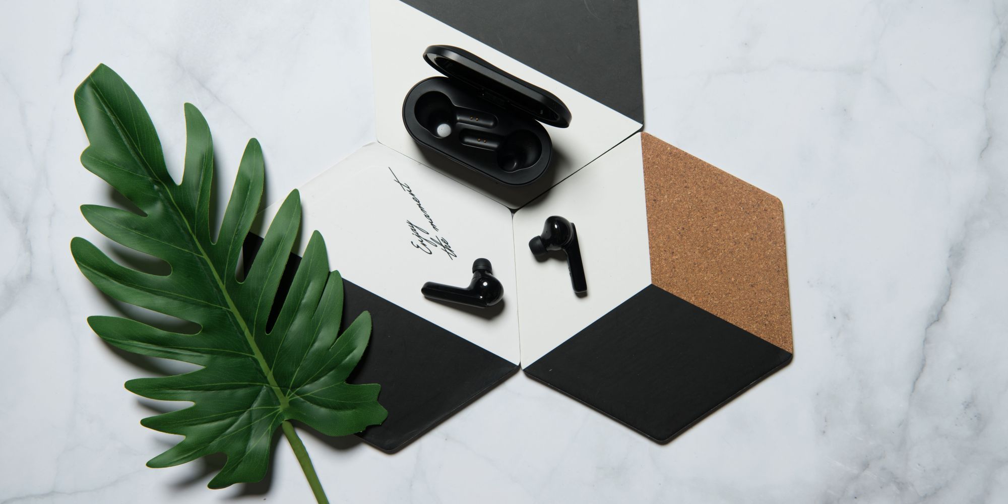 Mobvoi Earbuds Gesture earbuds with case on decorative tiles