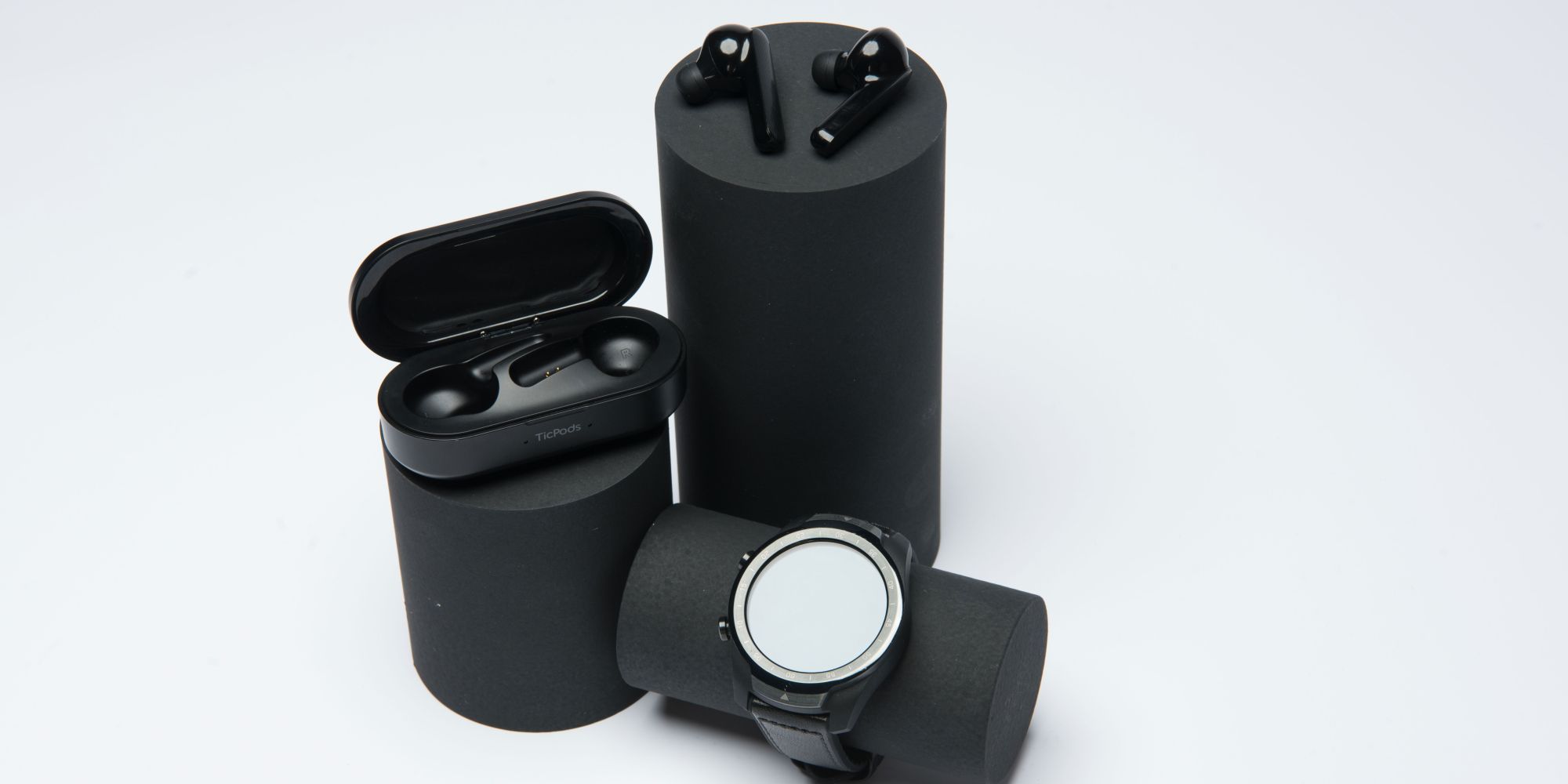 Mobvoi Earbuds Gesture earbuds with case and watch on display posts.