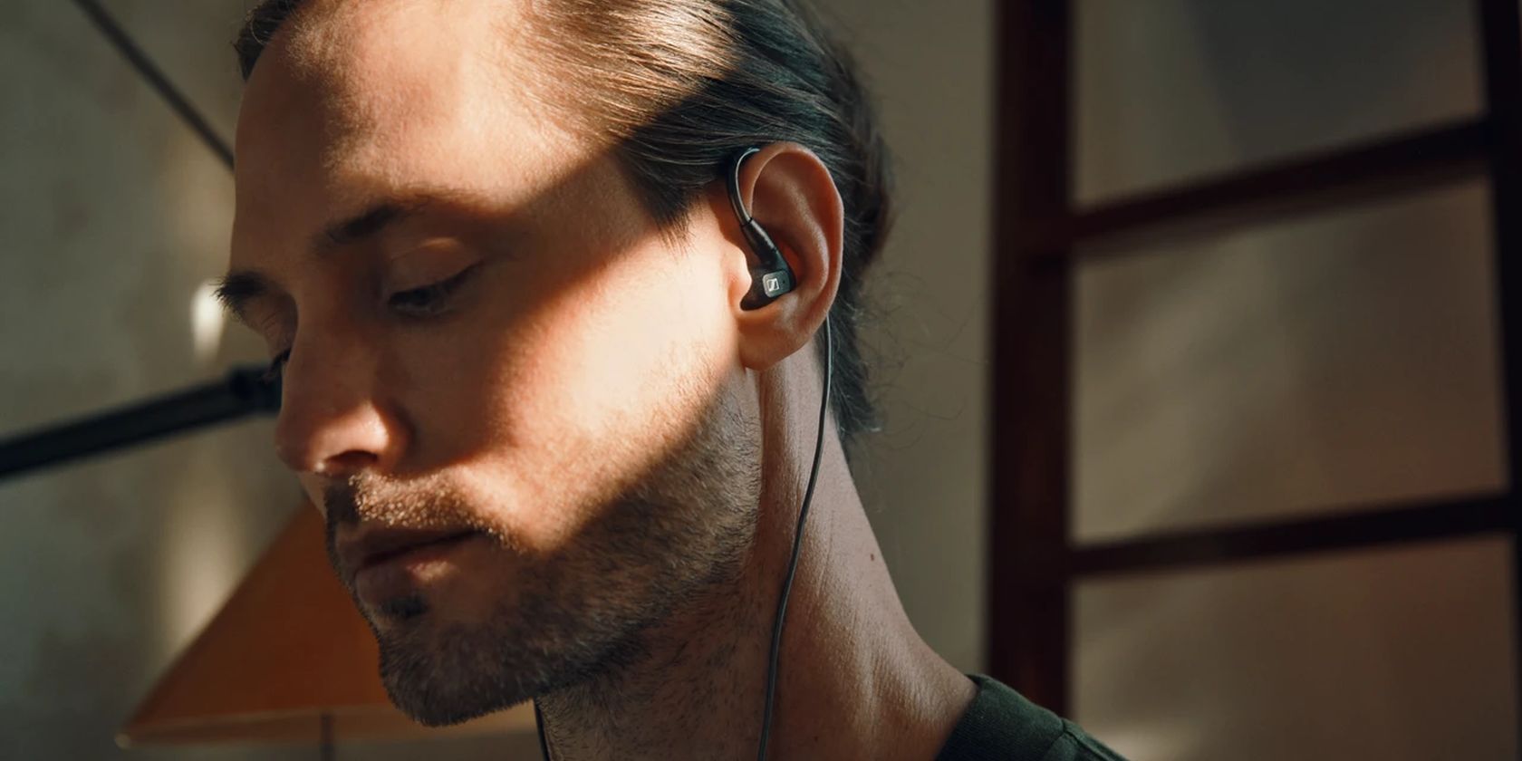 Sennheiser IE 300 in-ear headphones worn by young man.